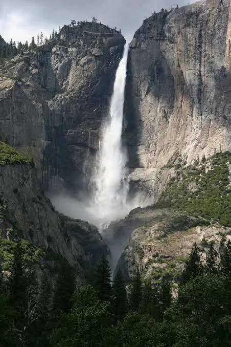 Yosemite Falls plunging between towering granite cliffs