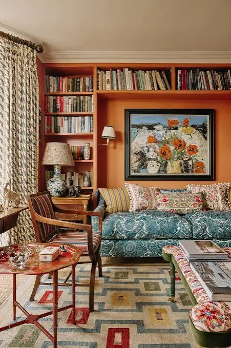 Eclectic bohemian living room with colorful textiles, layered patterns, and expressive artwork