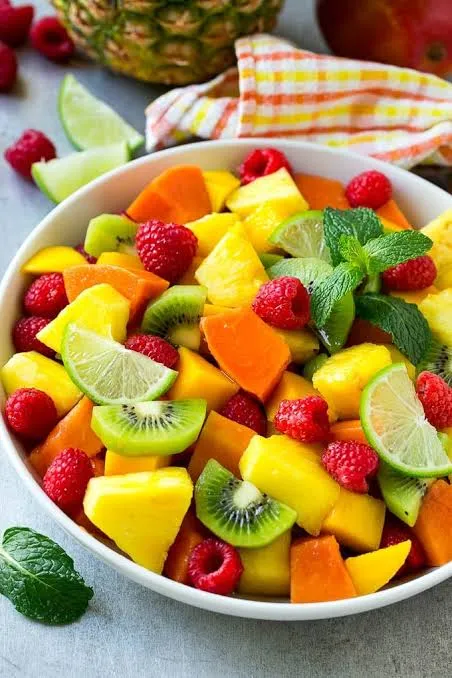 Fresh fruit salad with berries, mango, pineapple, citrus, and mint