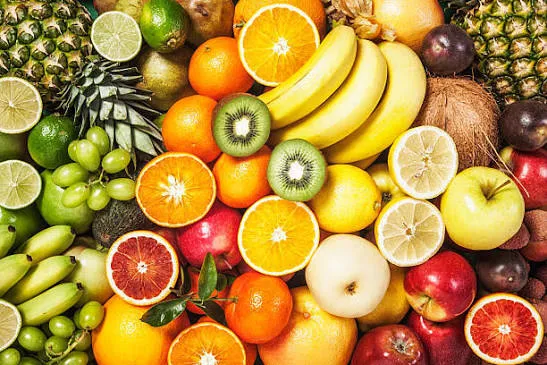 Colorful assortment of fresh whole and sliced fruits